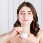 Woman applying lightweight face moisturiser suitable for hot UAE summer